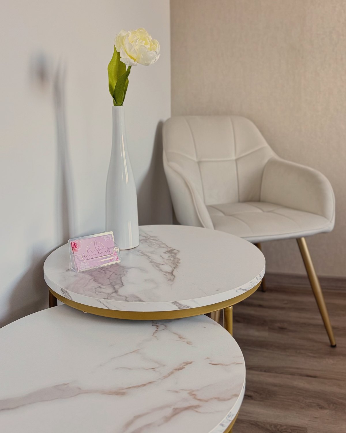 Sitzecke im Studio von Anna Kaul: Sessel und Beistelltisch mit einer Blume